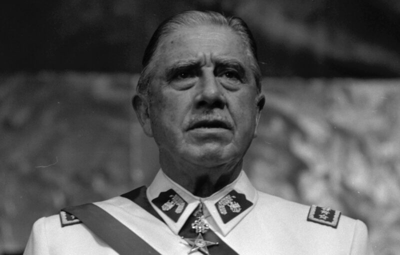 A black and white photo of Chilean dictator Augusto Pinochet.