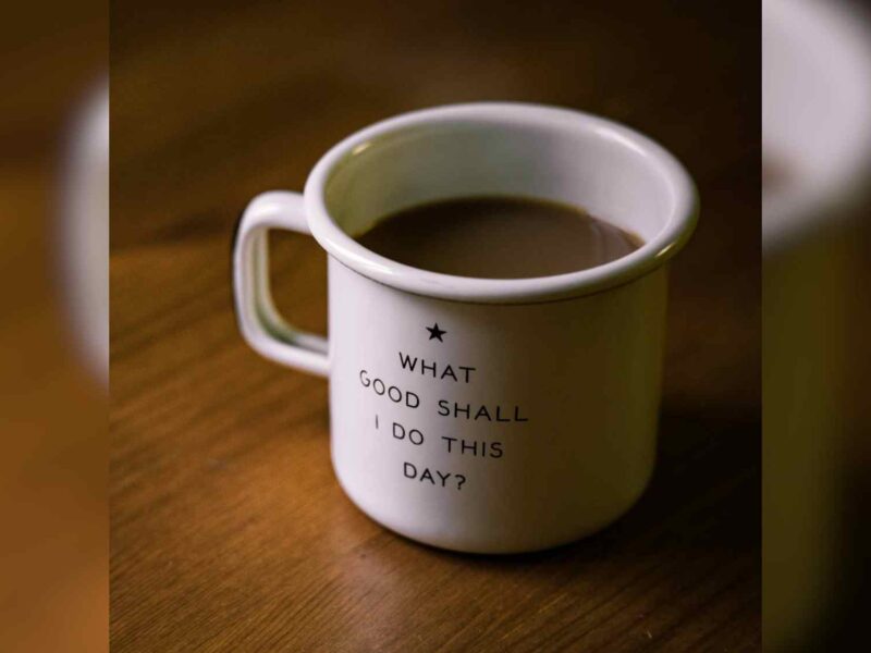 A coffee cup with the words "What Good Shall I Do Today" written on it.