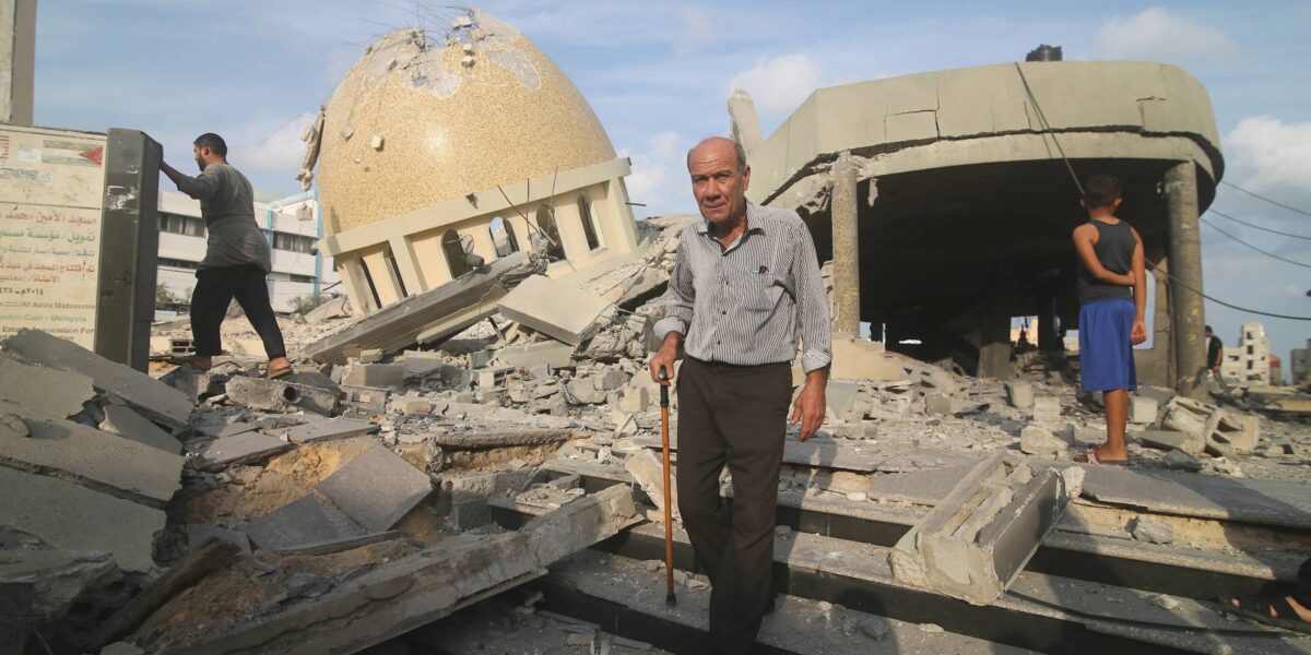 Palestinians inspect the ruins of a building destroyed in Israeli airstrikes in Khan Younis in the southern of Gaza strip, on October 8, 2023.