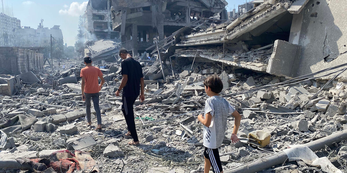 Palestinians inspect the damage following an Israeli airstrike on the El-Remal aera in Gaza City on October 9, 2023.