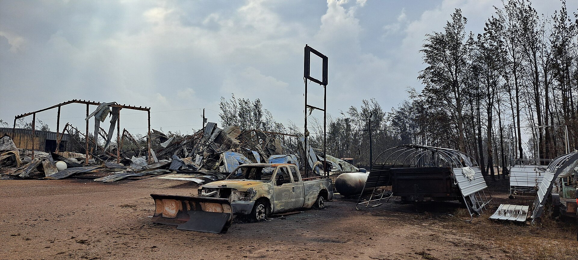 Enterprise NWT after the 2023 wildfires. With destroyed homes and vehicles.