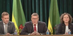 Saskatchewan Premier Scott Moe holds a news conference following the passage of the "parents' bill of rights," accompanied by Minister of Education Jeremy Cockrill (L) and Minister of Justice Bronwyn Eyre (R).