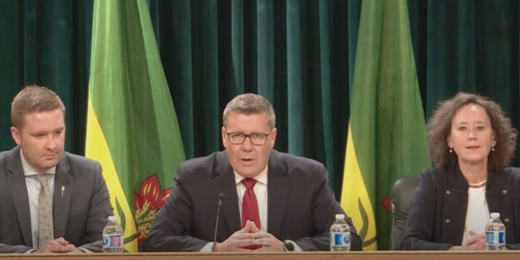 Saskatchewan Premier Scott Moe holds a news conference following the passage of the "parents' bill of rights," accompanied by Minister of Education Jeremy Cockrill (L) and Minister of Justice Bronwyn Eyre (R).