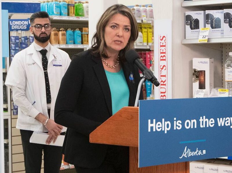 Alberta Premier Danielle Smith speaking in a pharmacy.