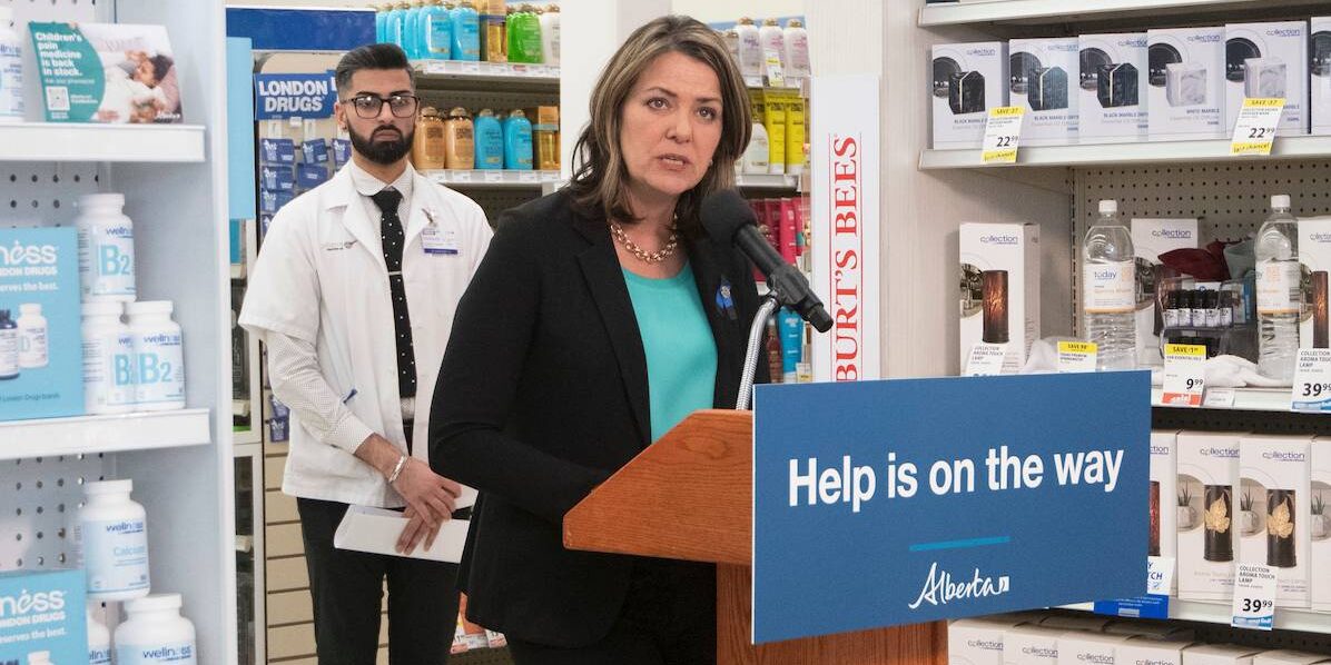 Alberta Premier Danielle Smith speaking in a pharmacy.