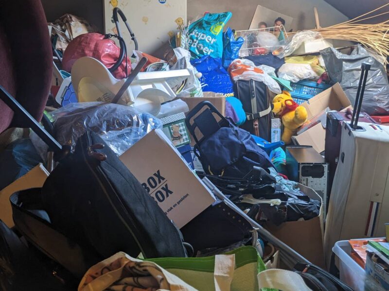 A room filled with piles of stuff. An example of hoarding.