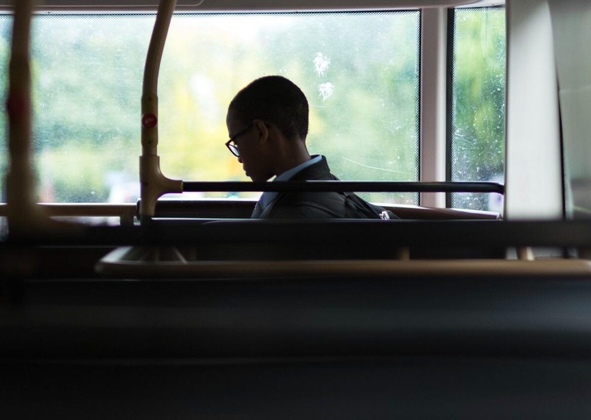 An image of a young child boarding a bus. Many Ebus drivers provide transport throughout Western Canada.