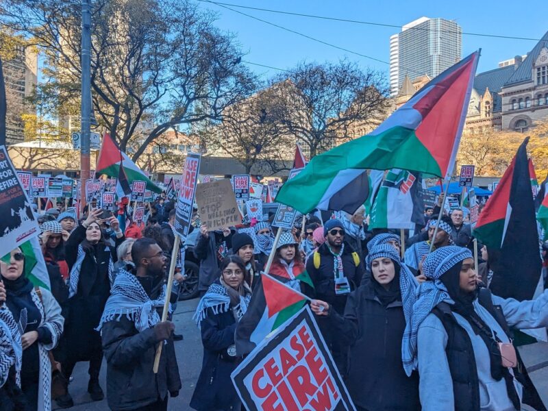 A rally in Toronto on November 12 calling for a ceasefire in Gaza. Palestinian flags are seen along with signs that read "Ceasefire Now."