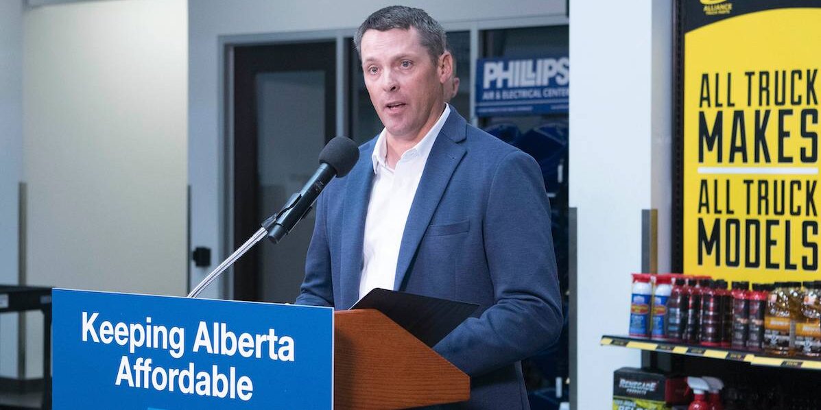 Alberta Finance Minister Nate Horner gives a speech behind a podium