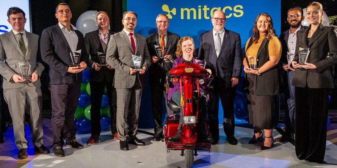 The 2023 Mitacs Awards winners holding their trophies in a group photo.