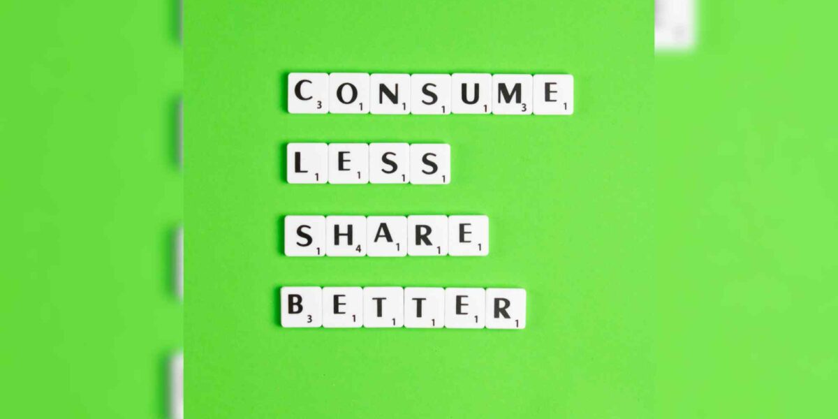 Letters on a green field reading: Consume less. Share better.