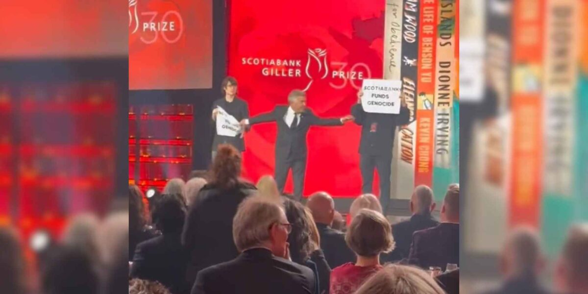 Protesters holding signs reading "Scotiabank funds genocide" at the 2023 Giller Prize Awards Gala.