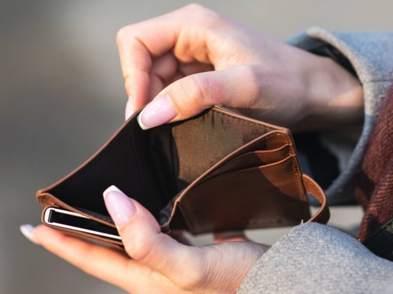 A woman holding an empty wallet.