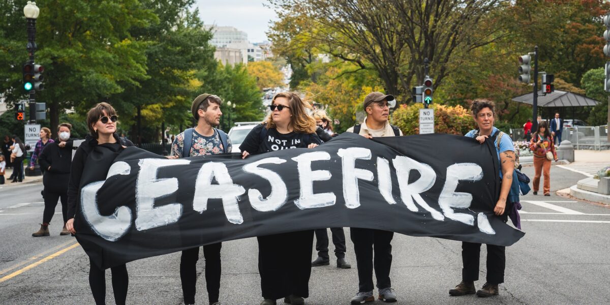 A group of people hold a banner reading "ceasefire" in Washington, D.C.