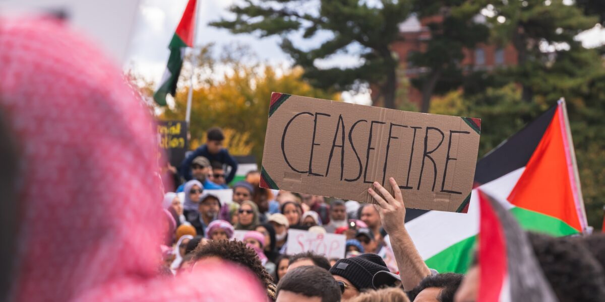 A person holds a sign reading "ceasefire" to protest Israel’s weeks-long bombardment of Gaza.