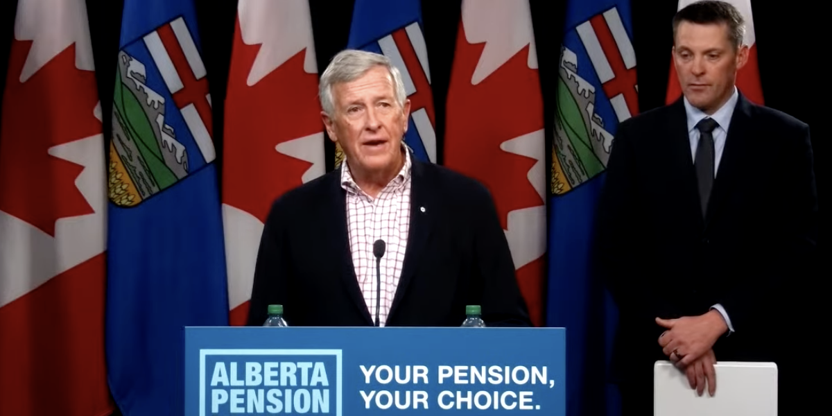 A worried looking Jim Dinning explains the “pause” in the planned Alberta pension plan campaign announced at the same newser by Finance Minister Nate Horner, looking sombre in the background.