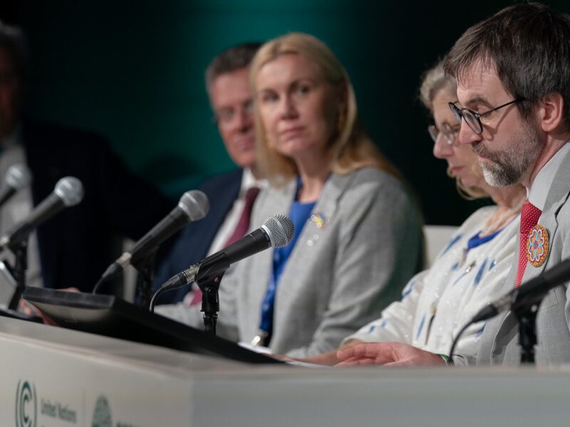 Canada's Environment Minister Steven Guilbeault sits at the far end of a table with other panelists at COP28.