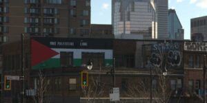 The restored mural of the Palestinian flag reading "Free Palestine Libre."