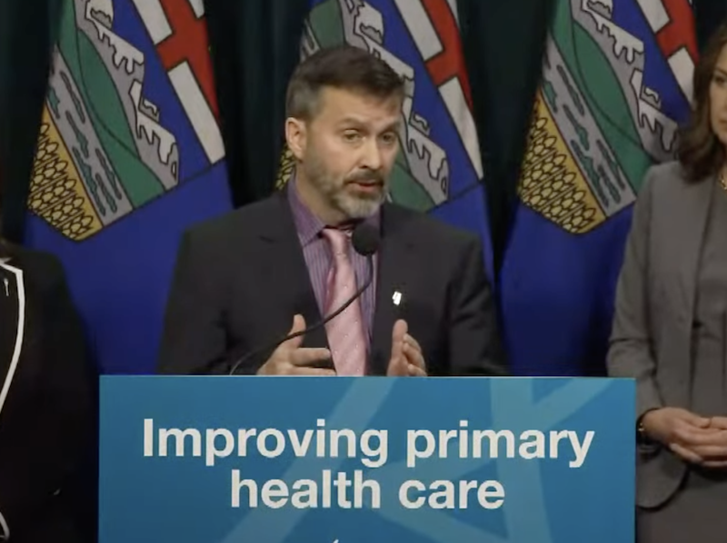 Three Alberta government officials, including Premier Danielle Smith, during a news conference.