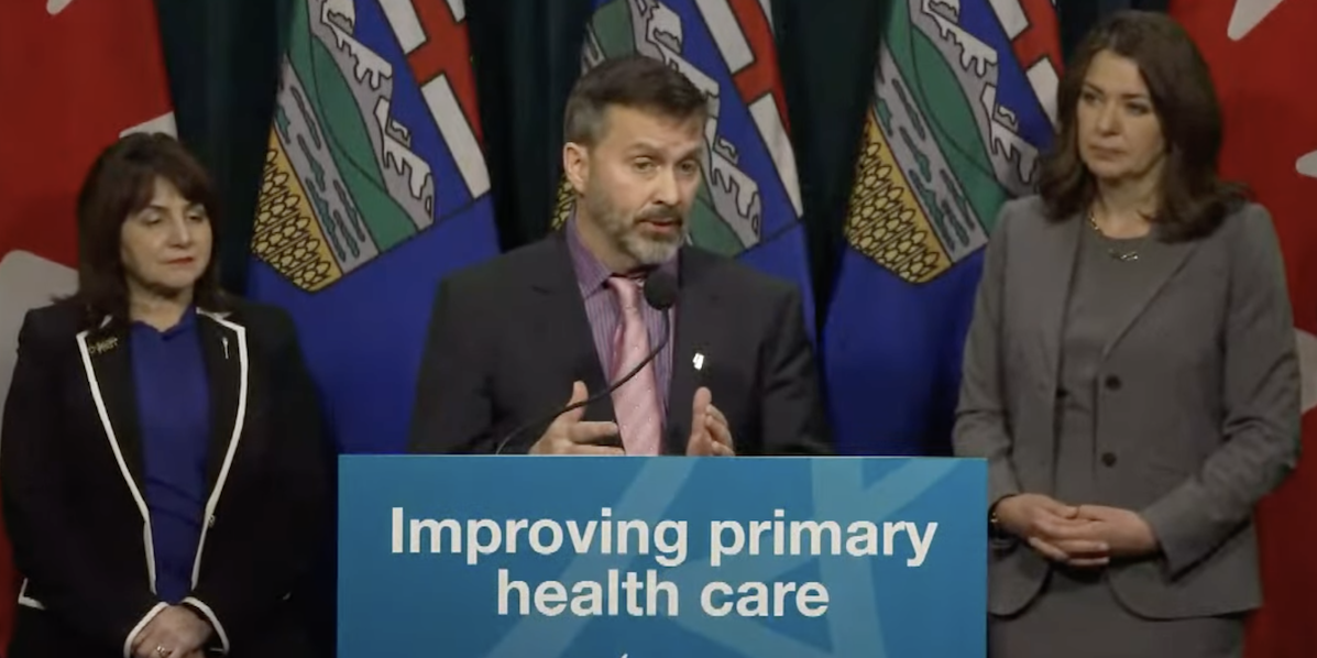 Three Alberta government officials, including Premier Danielle Smith, during a news conference.