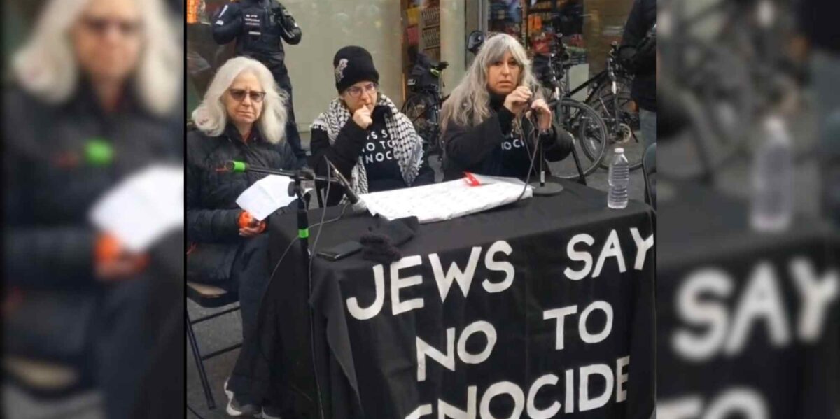 Three women sit at a table with microphones at a Jews say no to Genocide press conference that took place outside of an Indige Chapters bookstore on November 30.