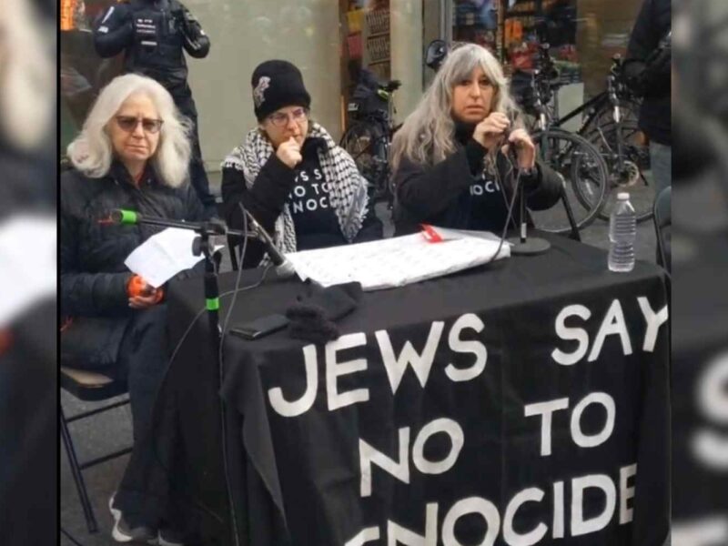 Three women sit at a table with microphones at a Jews say no to Genocide press conference that took place outside of an Indige Chapters bookstore on November 30.