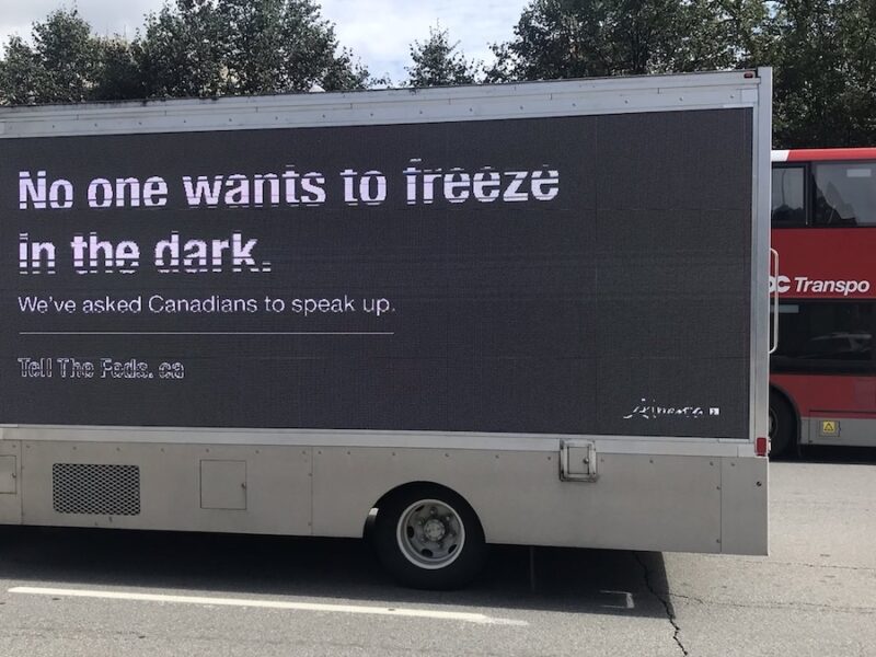 One of Alberta’s Freeze-in-the-Dark trucks makes its way past an OC Transpo bus in Ottawa last fall.
