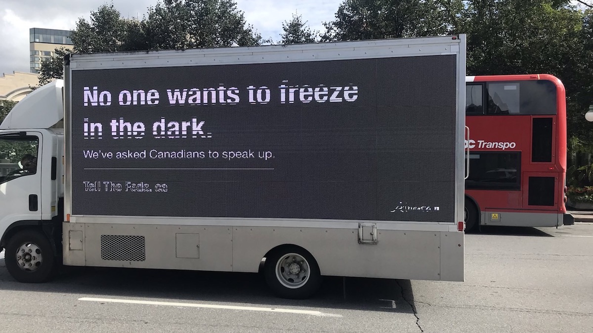 One of Alberta’s Freeze-in-the-Dark trucks makes its way past an OC Transpo bus in Ottawa last fall.