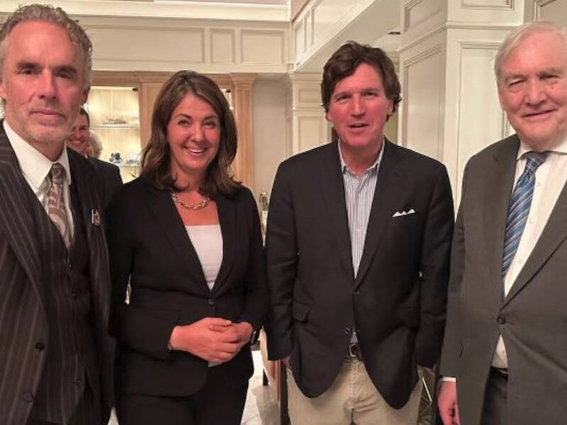 Alberta Premier Danielle Smith with three gentlemen of her acquaintance, Jordan Peterson, Tucker Carlson and Conrad Black, in Calgary.