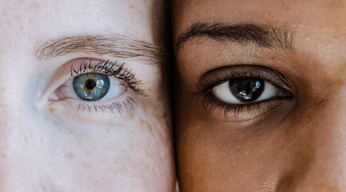 A white person and a Black person side by side, close up on faces, eyes.