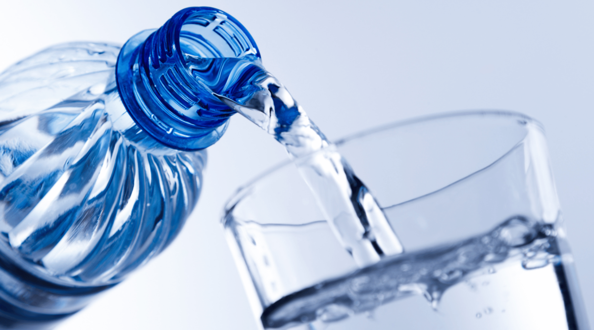 A photo of a water bottle being poured into a glass.