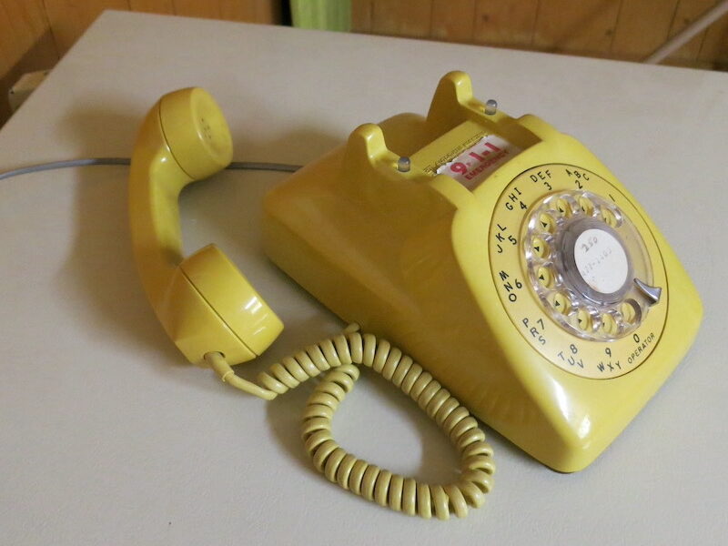 A yellow rotary phone.