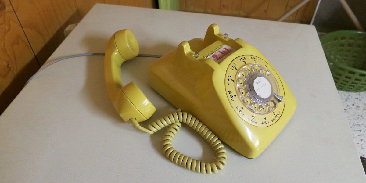 A yellow rotary phone.