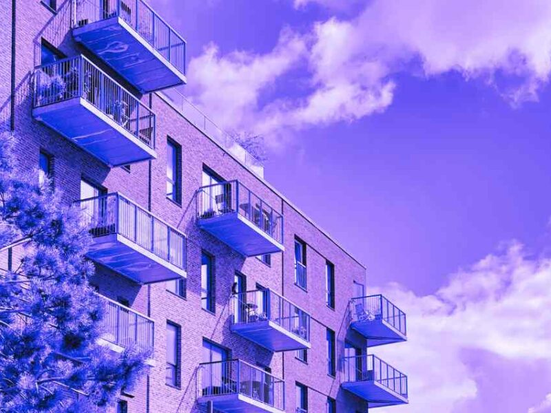 A view of apartment buildings with a purple filter.