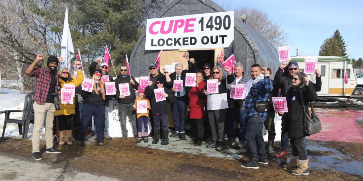 A group photo that includes members of the OFL,, OPSEU, CUPE Local 1490 and MP Charlie Angus.