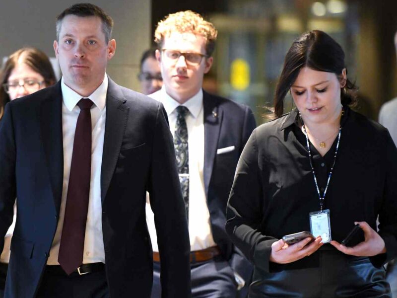 Alberta Finance Minister Nate Horner walking with staff.