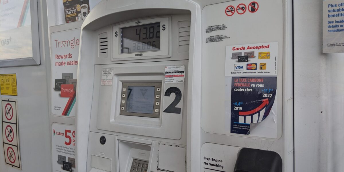 A gas pump with a government of Ontario carbon tax sticker on it.