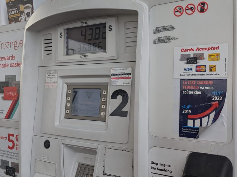 A gas pump with a government of Ontario carbon tax sticker on it.