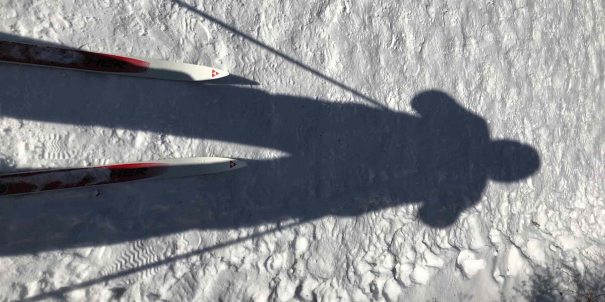 A person's shadow over some snow.