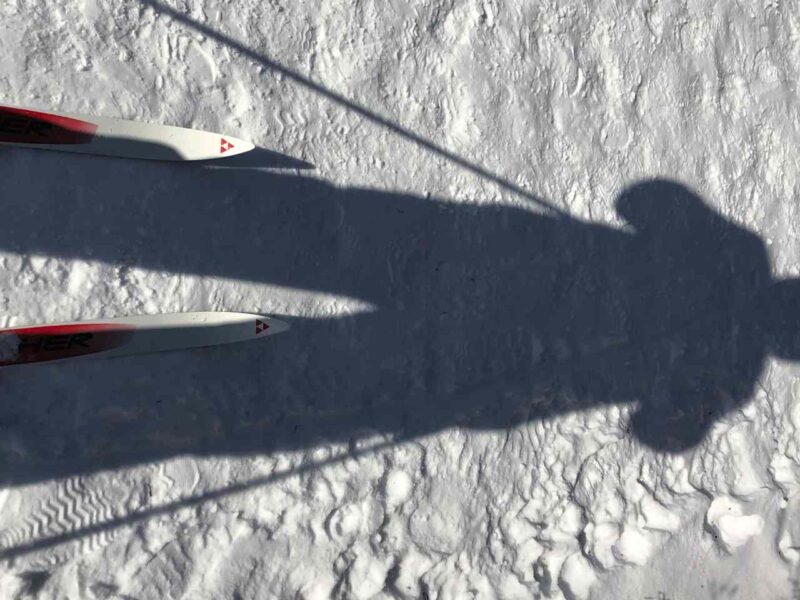 A person's shadow over some snow.