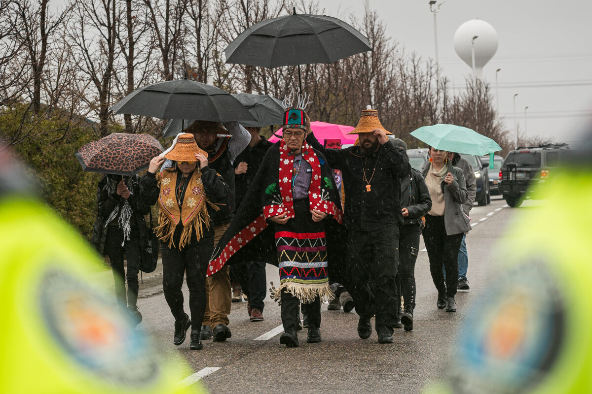 Wet'suwet'un Hereditary Chief Na'Moks and land defenders join the rally outside of RBC's 2024 AGM.