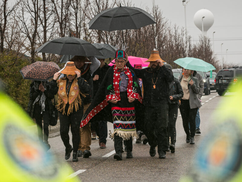 Wet'suwet'un Hereditary Chief Na'Moks and land defenders join the rally outside of RBC's 2024 AGM.