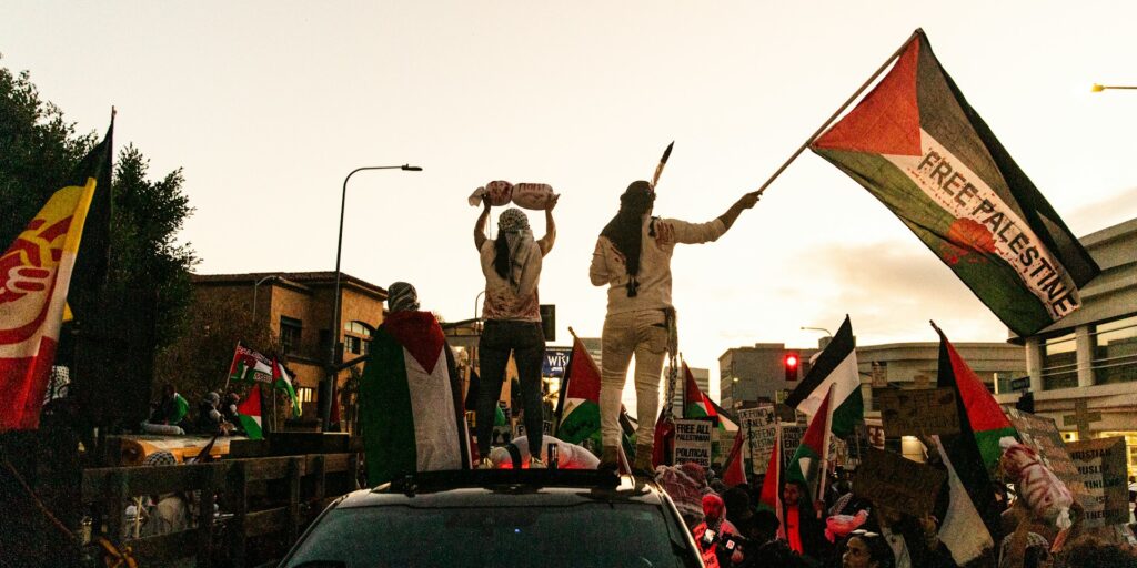 Where do you draw the line of disruption? People stand on a vehicle at a Gaza protest.