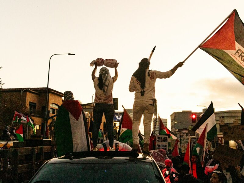 Where do you draw the line of disruption? People stand on a vehicle at a Gaza protest.