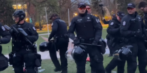 Edmonton Police Service members clearing out the University of Alberta encampment Saturday morning.