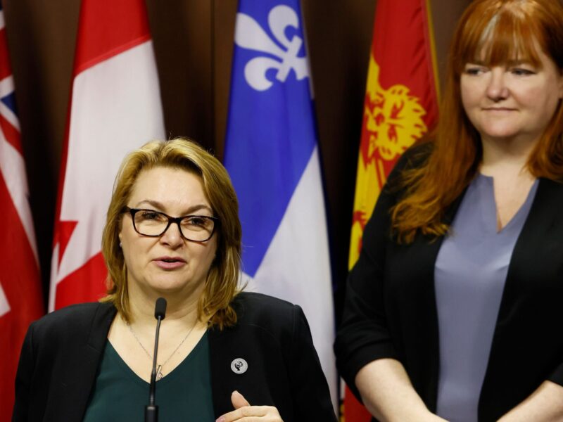 CLC president Bea Bruske speaking at a podium with executive vice president of the Canadian Labour Congress Siobhán Vipond standing behind her.