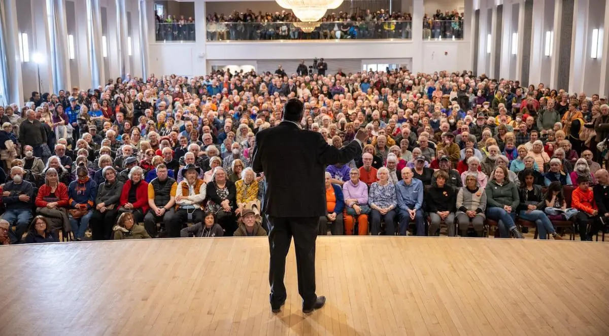 NDP leadership frontrunner Naheed Nenshi on stage.