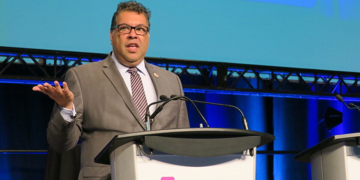 Former Calgary mayor Naheed Nenshi pictured speaking at a podium in 2017.