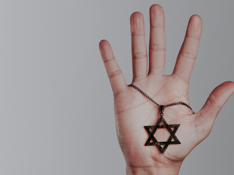 A hand holding a Star of David.
