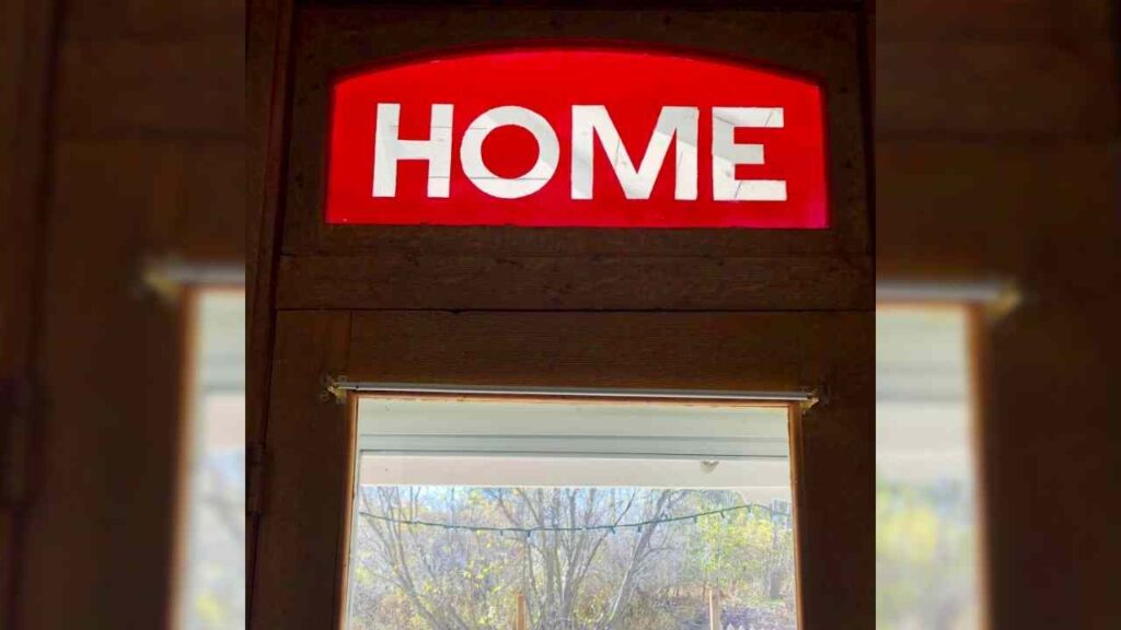 The word "home" hangs over a doorway.